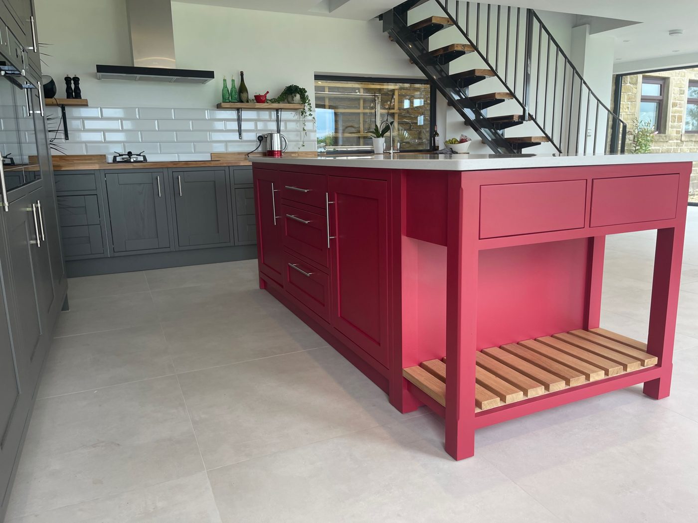 Painted kitchen island with open-tread oak staircase