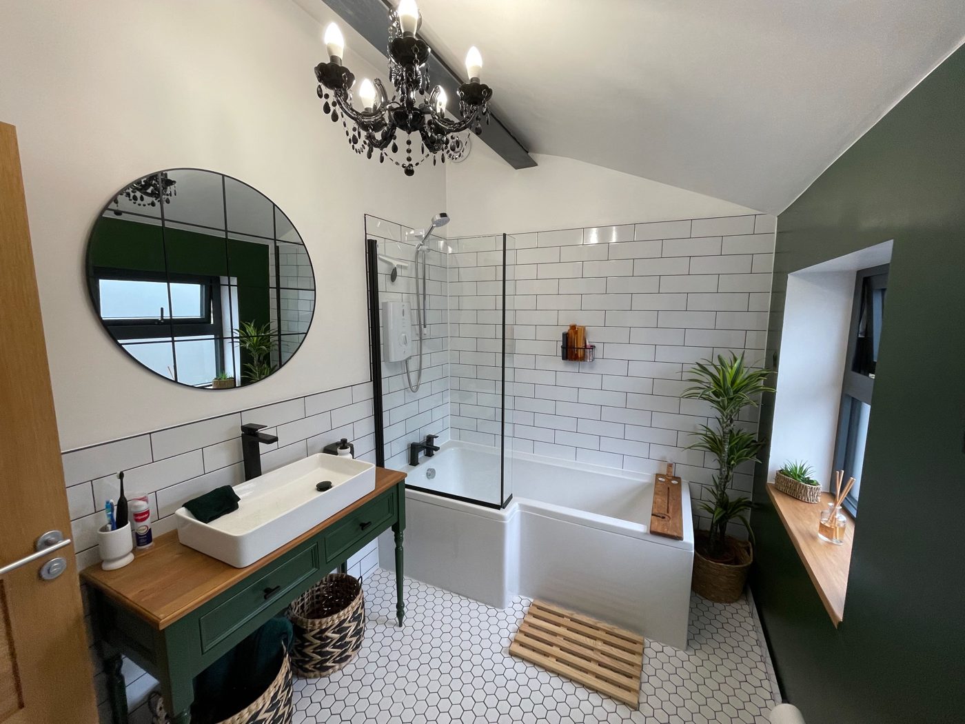 Bathroom with green vanity and subway tile